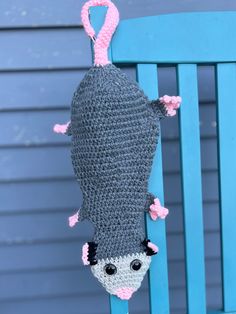 a crocheted stuffed animal hanging from a blue chair