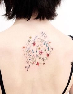 the back of a woman's shoulder with flowers on it