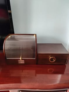 an old radio sitting on top of a wooden desk