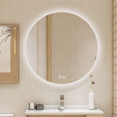 a bathroom with a round mirror on the wall and a white sink in front of it