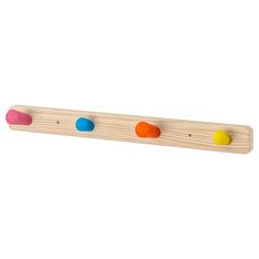 a wooden peg board with four colored dots on the top and one in the middle