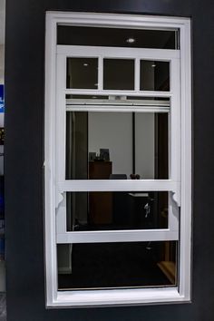 an open window in a room with black walls and white trim on the windowsill