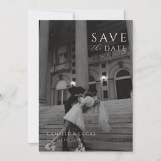 a black and white photo of a couple kissing in front of a building with the words save the date on it