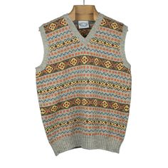 The most iconic example of classic Fair Isle design, sleeveless for ease to wear under a sport coat. Fair Isle is a knitting technique that takes its name from a tiny Shetland island and creates multicolor geometric patterns, knitted in rows. It was popularized by the Duke of Windsor and has become a traditional cold weather knit. Details 100% authentic Shetland wool, spun on the island 2-ply wool yarns; traditional Fair Isle design Ribbed collar, cuffs and hem Knitted and hand-linked on the She Mint Green And Pink, Duke Of Windsor, Island 2, Sweater Vests, Shetland Wool, Fair Isle Sweater, Knitting Techniques, The Fair, Navy And Green