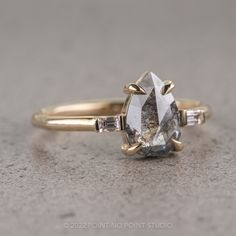 a close up of a diamond ring on a table