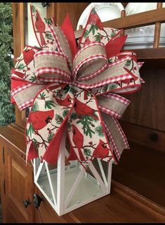 a red and white bow hanging from the side of a cabinet