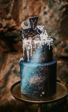 a black and blue cake with white icing on top