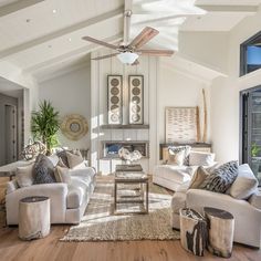 a living room filled with furniture and a ceiling fan in the middle of the room