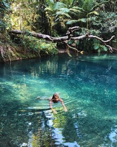 a woman swimming in the middle of a river