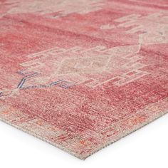 an orange and pink rug on a white surface