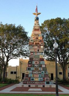 a tall tower made out of books in front of a building