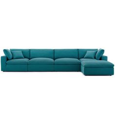 a blue sectional couch with pillows on the top and bottom, in front of a white background