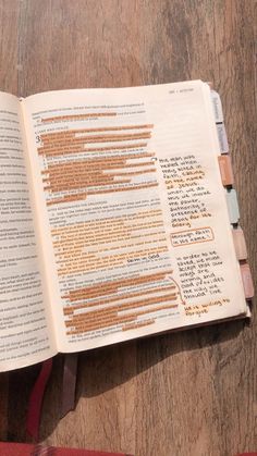 an open book sitting on top of a wooden table