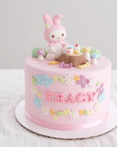 there is a pink cake decorated with flowers and an animal on the top that says treat