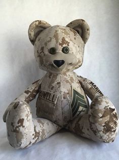 a stuffed teddy bear is sitting on a white background