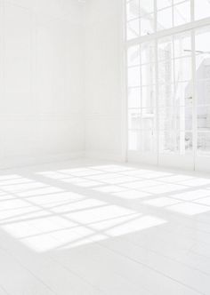 an empty room with white walls and floor