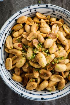 a white and blue bowl filled with nuts