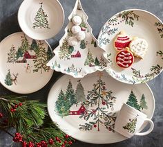 christmas themed plates and cups on a table