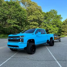 a bright blue truck parked in a parking lot