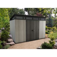 a small storage shed in the middle of a garden