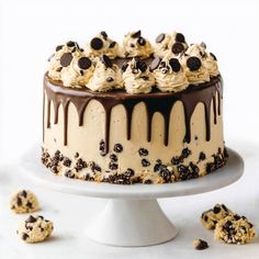 a cake with chocolate chips and cookies on top