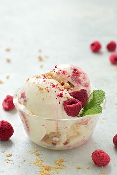 an ice cream sundae with raspberries and mint