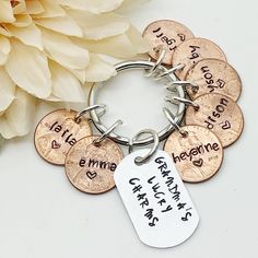 a bunch of coins that are on a keychain next to a white flower