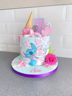 a birthday cake decorated with pink and blue frosting