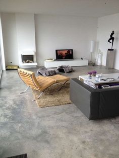 a living room filled with furniture and a flat screen tv mounted to the side of a wall