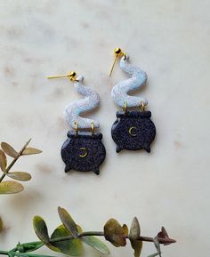 the earrings are made out of black and white marble