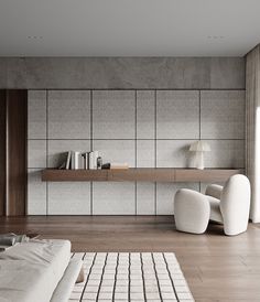 a modern living room with white furniture and wood flooring, along with bookshelves