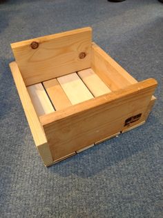 a wooden box sitting on top of a blue carpet