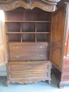 an antique dresser and armoire in a room