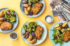 three plates with different types of food on them and silverware next to each other