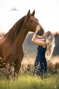 a beautiful blonde woman standing next to a brown horse