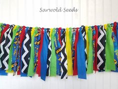 the colorful streamers are hanging on the wall in front of the white door that says sawwold seeds