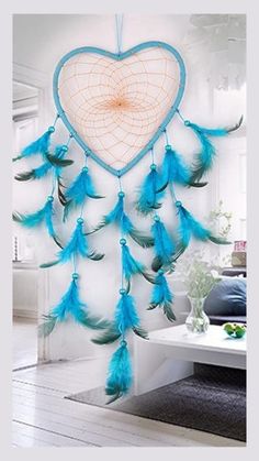 a heart shaped dream catcher hanging on the wall