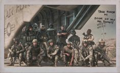 a group of soldiers posing for a photo in front of an airplane with words written on it