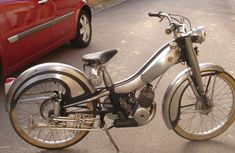 an old motorcycle is parked on the street