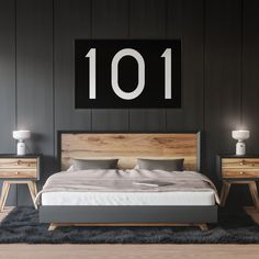 a bedroom with black walls and wooden furniture