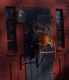 a potted plant is hanging on the side of a red door