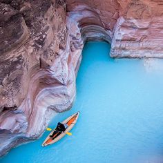 a person in a kayak floating on the blue water