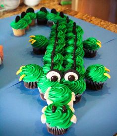 cupcakes with green frosting decorated like a dragon