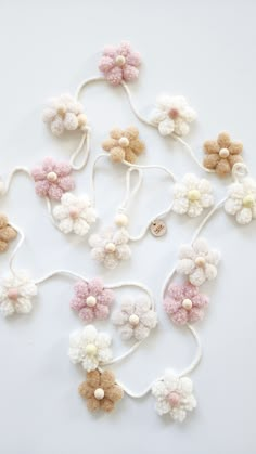 crocheted flowers are arranged on a white surface