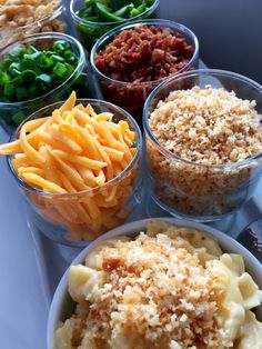 four bowls filled with different types of food on a table top next to each other