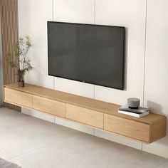 a flat screen tv mounted to the side of a wall