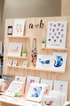 an assortment of greeting cards displayed on wooden shelves