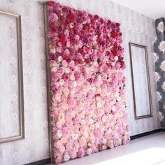 a large flowered wall in the corner of a room next to two framed pictures