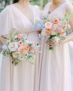 two bridesmaids in pink dresses holding bouquets