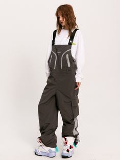 The Solaris Technical Overalls feature a wind + water-resistant nylon blend construction in a loose fit. Logo print and trim detail to the bib alongside concealed zip closure pockets. Buckle embellished shoulder straps with an adjustable waist buckle and belt loops. Cargo pockets to the legs with hardware drawcord cuffs. Rubberized logo patch to the back finished off with signature GRKC garment labels. Wind + Water Resistant Bib Overalls Buckle Shoulder Straps Cargo Pockets No Restocks Unisex Mo Cyberpunk Overalls, Overalls Reference, Subtle Poses, Mechanic Outfit, Mechanic Clothes, Cargo Overalls, Tech Outfit, Work Overalls, Architecture People